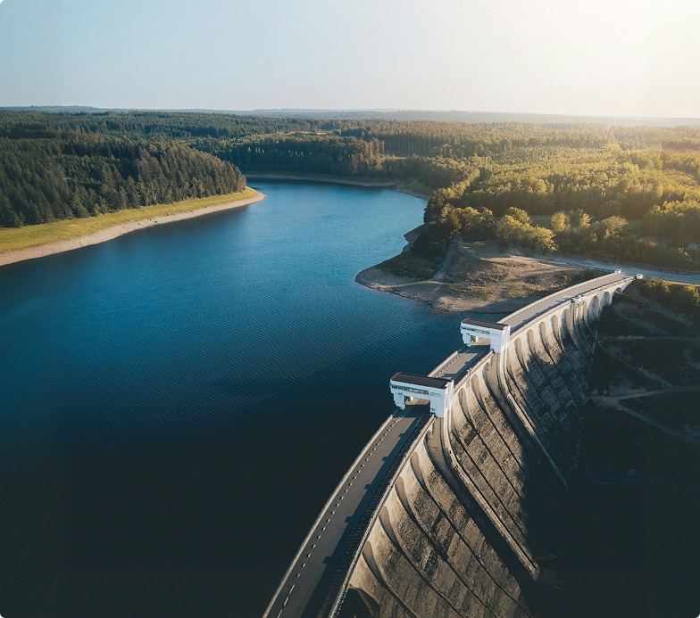 Shows a closed dam holding back a river