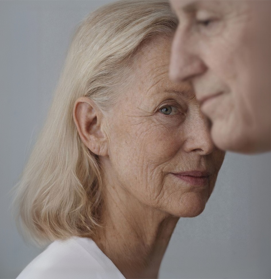 An older woman and man looking optimistic